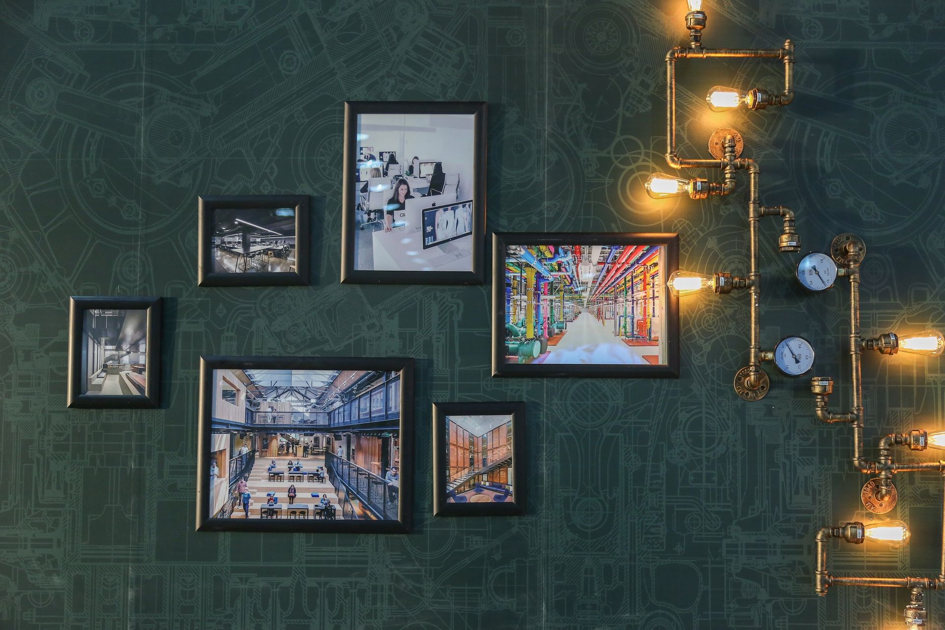 A bunch of pictures are hanging on a wall.